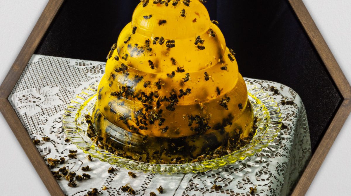 Yellow gelatin in the shape of a beehive, filled with bees.